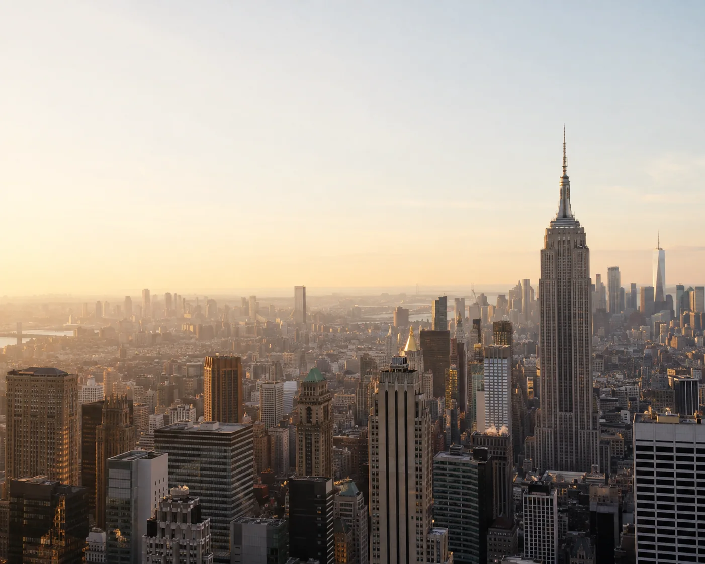 Midtown Manhattan at golden hour, the Empire State Building against a pale sky